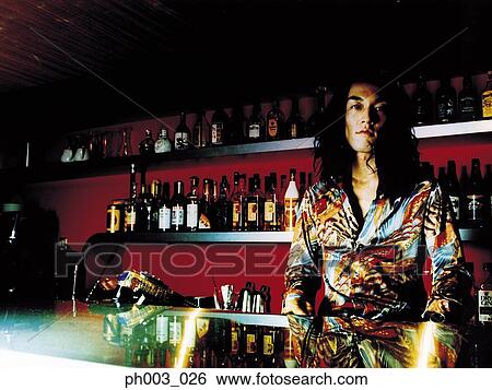 Stock Photograph - Bartender behind a bar counter. Fotosearch
