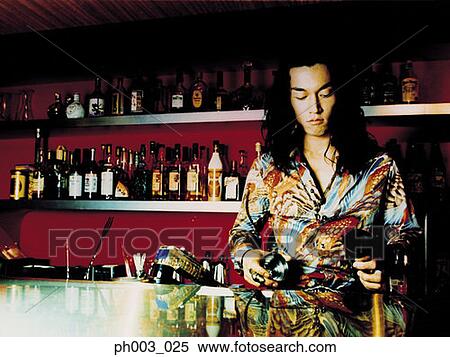 Stock Photography - Bartender behind a bar counter. Fotosearch