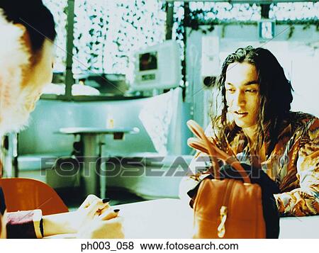Couple at a café View Large Photo Image Stock Photo - Couple at a café. Fotosearch