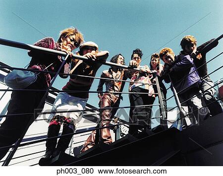Stock Image - Group of young people at staircase, elevated view. Fotosearch