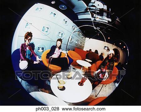 Stock Photo - Three Asian women chatting at a café. Fotosearch