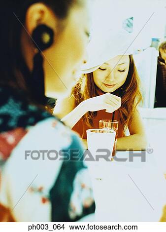 Two Asian women at a café View Large Photo Image Picture - Two Asian women at a café. Fotosearch