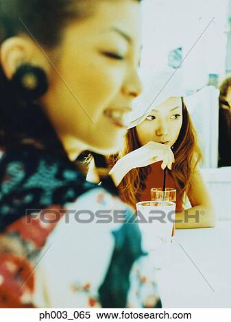 Two Asian women at a café View Large Photo Image Stock Photography - Two Asian women at a café. Fotosearch