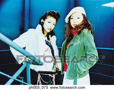 Two women standing at a flight of stairs View Large Photo Image Stock Image - Two women standing at a flight of stairs. Fotosearch