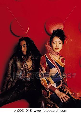 Stock Photo - Young Asian couple, emotional distress, close-up. Fotosearch