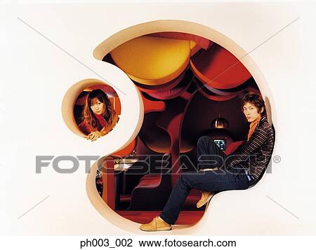 Stock Image - Young Asian couple, odd shape wall. Fotosearch