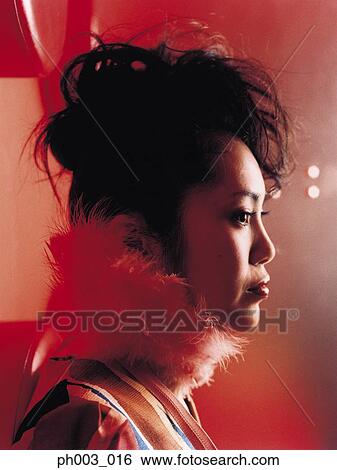 Stock Photograph - Young Asian woman, profile, close-up. Fotosearch