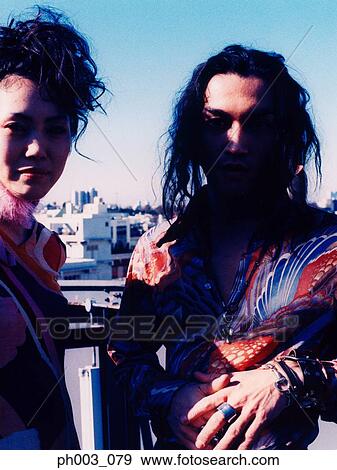Stock Photo - Young couple standing at rooftop, close up. Fotosearch