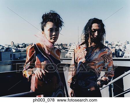 Young couple standing at rooftop View Large Photo Image Stock Photo - Young couple standing at rooftop. Fotosearch