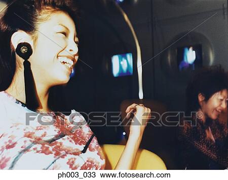 Stock Image - Young woman laughing, portrait . Fotosearch