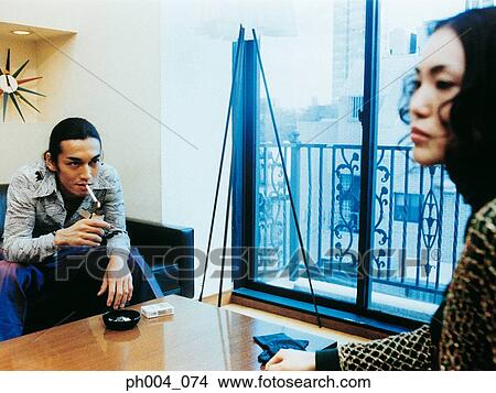 A bored couple at the coffee table View Large Photo Image Picture - A bored couple at the coffee table. Fotosearch
