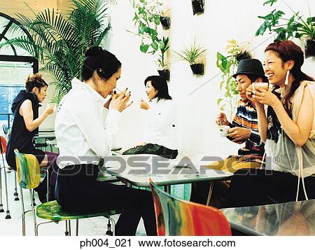 Stock Image - Group of young adults at a café. Fotosearch