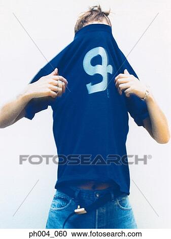Man dressing, tee shirt pulled over head, close-up View Large Photo Image Stock Image - Man dressing, tee shirt pulled over head, close-up. Fotosearch