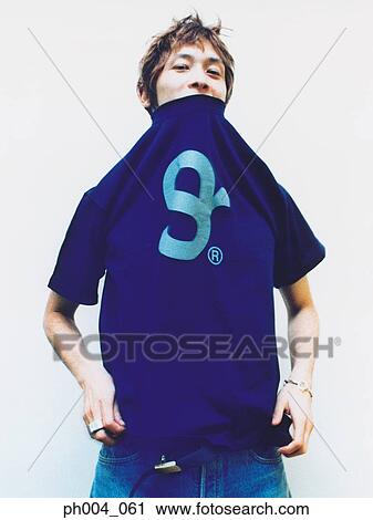 Man dressing, tee shirt pulled over head, close-up View Large Photo Image Stock Image - Man dressing, tee shirt pulled over head, close-up. Fotosearch