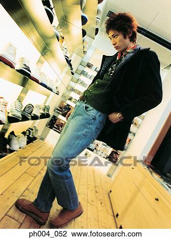 Man looking at display of shoes View Large Photo Image Stock Image - Man looking at display of shoes. Fotosearch