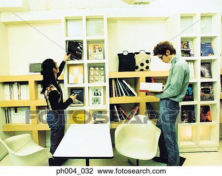 Stock Image - Two young men reading books and magazines. Fotosearch