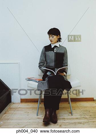 Woman reading in cushion chair View Large Photo Image Stock Image - Woman reading in cushion chair. Fotosearch