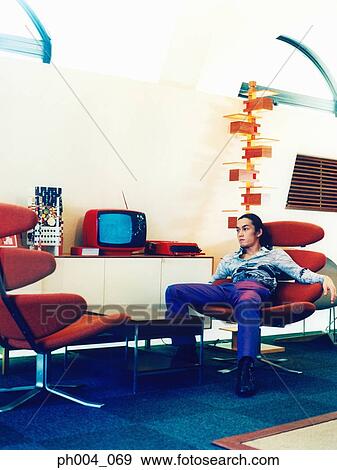 young man relaxing in chair View Large Photo Image Stock Photo - young man relaxing in chair . Fotosearch