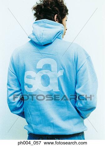 Stock Photo - Young man wearing sweatshirt with hood, rear view. Fotosearch