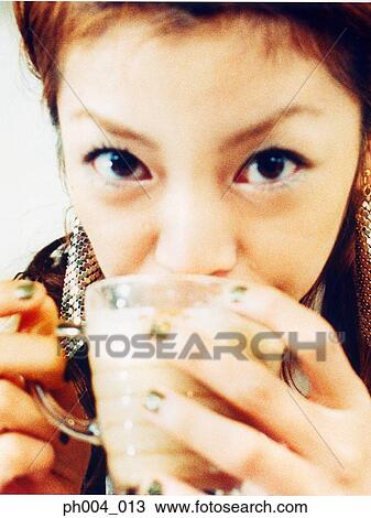 Young woman drinking cup of coffee, portrait, close-up View Large Photo Image Stock Image - Young woman drinking cup of coffee, portrait, close-up . Fotosearch