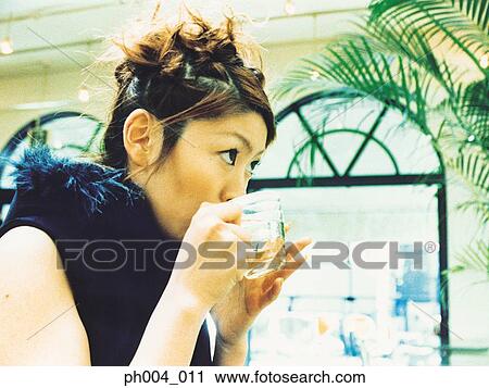 Young woman drinking glass of water View Large Photo Image Stock Image - Young woman drinking glass of water. Fotosearch