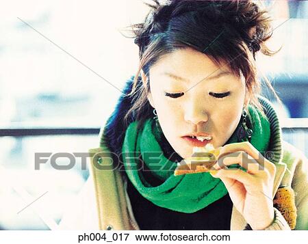Young woman eating toast, close-up View Large Photo Image Stock Photo - Young woman eating toast, close-up. Fotosearch