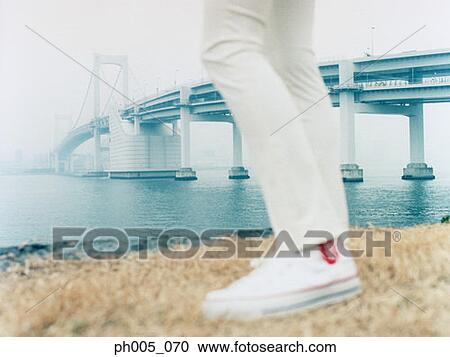 Woman at waterfront, near bridge View Large Photo Image Stock Image - Woman at waterfront, near bridge. Fotosearch