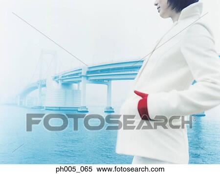 Stock Photography - Woman at waterfront, portrait. Fotosearch