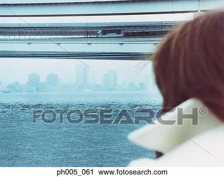 Woman at waterfront, rear view View Large Photo Image Stock Image - Woman at waterfront, rear view. Fotosearch