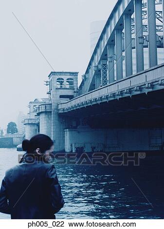 Woman standing near bridge View Large Photo Image Stock Image - Woman standing near bridge. Fotosearch