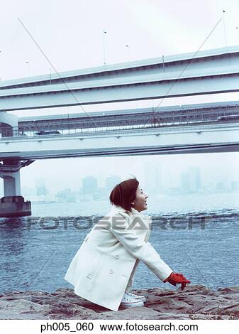 Young woman at waterfront, close up View Large Photo Image Stock Image - Young woman at waterfront, close up. Fotosearch