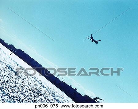 Airplane over harbor, silhouette, Tokyo Bay, Japan View Large Photo Image Stock Photography - Airplane over harbor, silhouette, Tokyo Bay, Japan. Fotosearch