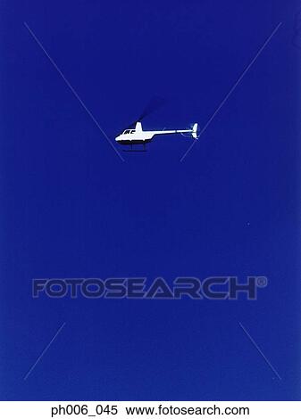 View of a helicopter flying in the sky. View Large Photo Image Stock Photography - View of a helicopter flying in the sky. . Fotosearch