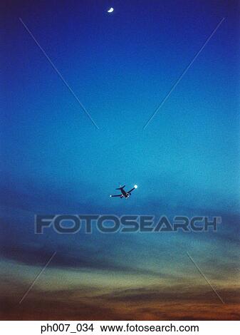 Passenger aircraft flying, elevated view View Large Photo Image Picture - Passenger aircraft flying, elevated view. Fotosearch