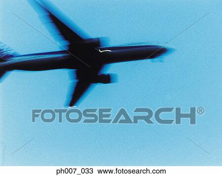 Passenger aircraft flying, elevated view View Large Photo Image Stock Image - Passenger aircraft flying, elevated view. Fotosearch