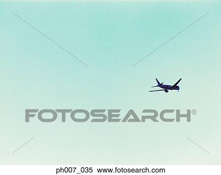 Stock Photography - Passenger aircraft flying, elevated view. Fotosearch