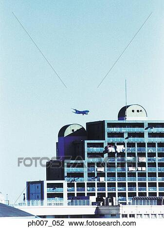 Passenger aircraft flying over building, Tokyo Bay, Japan View Large Photo Image Stock Image - Passenger aircraft flying over building, Tokyo Bay, Japan. Fotosearch