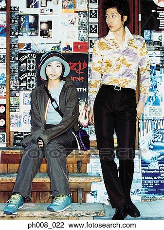 Stock Image - Couple outside a shop. Fotosearch