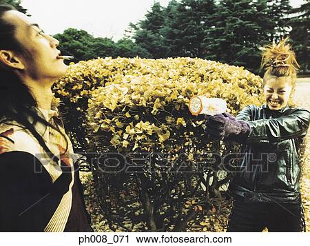 Stock Image - Couple playing in a park. Fotosearch