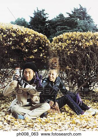 Stock Image - Couple sitting in a park. Fotosearch