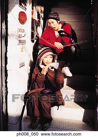 Couple sitting on staircase View Large Photo Image Stock Image - Couple sitting on staircase. Fotosearch
