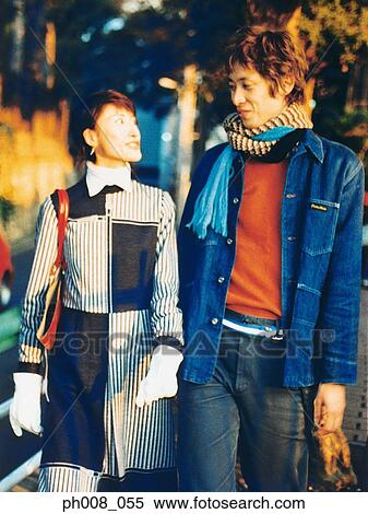 Couple walking in a park View Large Photo Image Stock Photography - Couple walking in a park. Fotosearch