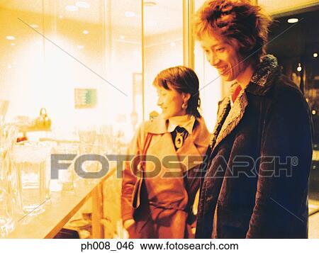 Couple window shopping View Large Photo Image Stock Photograph - Couple window shopping. Fotosearch