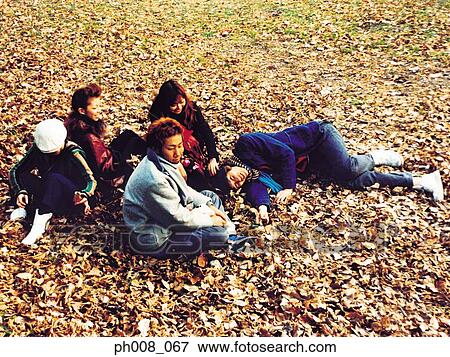 Group of people in a park View Large Photo Image Stock Photo - Group of people in a park. Fotosearch