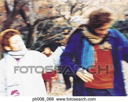 Group of people in a park View Large Photo Image Stock Photo - Group of people in a park. Fotosearch