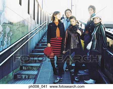 Group of people standing on staircase View Large Photo Image Stock Image - Group of people standing on staircase. Fotosearch