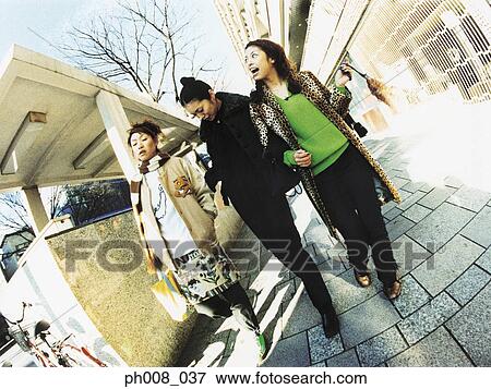 Group of people walking on the street View Large Photo Image Stock Photo - Group of people walking on the street. Fotosearch