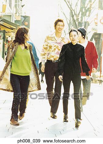 Group of people walking on the street View Large Photo Image Stock Photo - Group of people walking on the street. Fotosearch