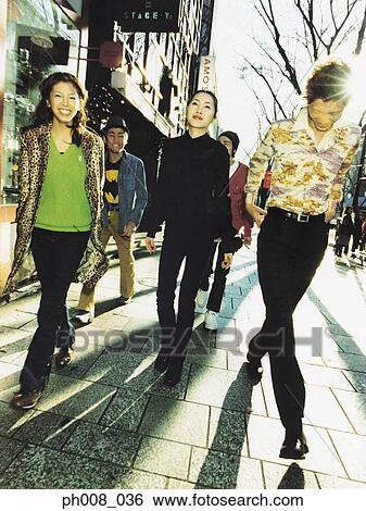 Stock Photograph - Group of people walking on the street. Fotosearch