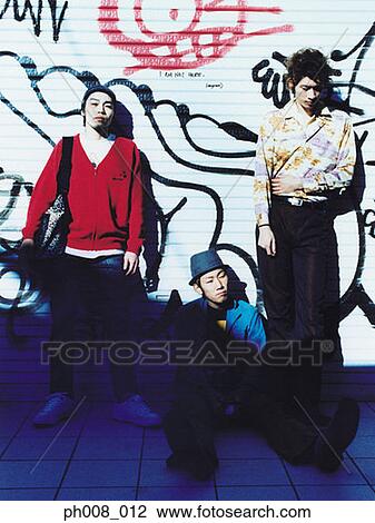 Three young men leaning against vandalized wall View Large Photo Image Stock Image - Three young men leaning against vandalized wall. Fotosearch